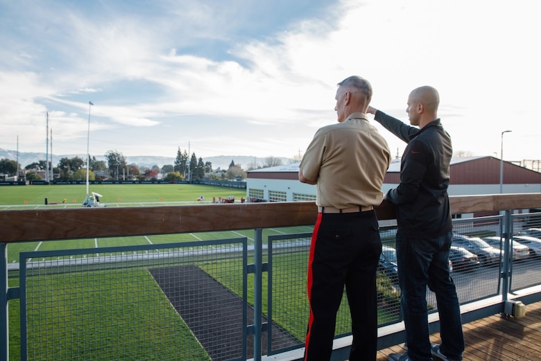 Lieutenant General Rex C. McMillian, commander of Marine Forces Reserve and Marine Forces North and Brandon Moreno, community relations manager for the 49ers, stand on a deck overlooking the National Football League’s San Francisco 49ers practice field, Nov. 4, 2016, and discuss the training that leads up to game day. McMillian was invited to observe a 49ers’ practice session in preparation for Sunday’s “Salute to Service” game against the New Orleans Saints at Levi’s Stadium. The half-time show of Sunday’s game will recognize the Marine Forces Reserve Centennial. Today, approximately 500 Reserve Marines are providing fully integrated global operational support to the Fleet and Combatant Commanders. For more information on the history and heritage of Marine Forces Reserve as well as current Marine stories and upcoming Centennial events, please visit www.marines.mil/usmcr100. (U.S. Marine Corps photo by Lance Cpl. Dallas Johnson)