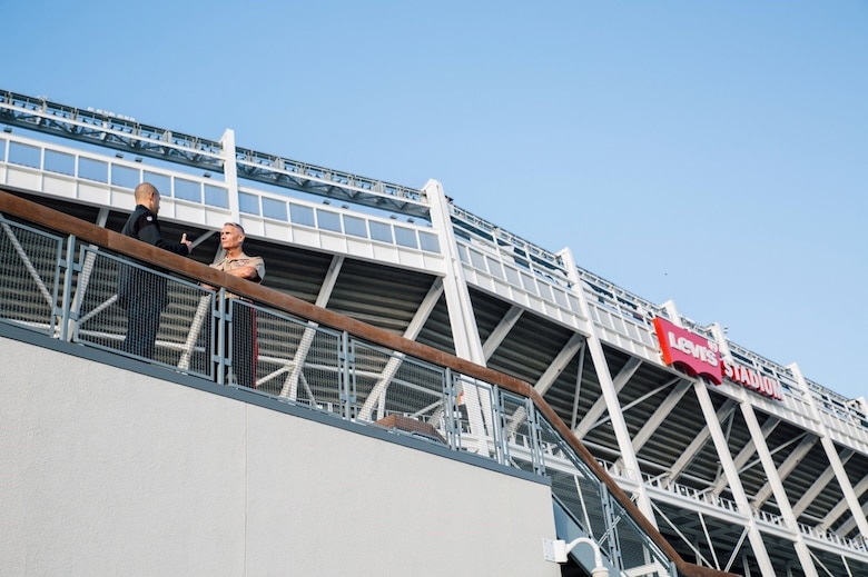 Lieutenant General Rex C. McMillian, commander of Marine Forces Reserve and Marine Forces North, and Brandon Moreno, community relations manager for the 49ers, stand on a deck overlooking the National Football League’s San Francisco 49ers practice field, Nov. 4, 2016, and discuss the training that leads up to game day. McMillian was invited to observe a 49ers’ practice session in preparation for Sunday’s “Salute to Service” game against the New Orleans Saints at Levi’s Stadium. The half-time show of Sunday’s game will recognize the Marine Forces Reserve Centennial.   Today, approximately 500 Reserve Marines are providing fully integrated operational support to Fleet and Combatant Commanders around the world. For more information on the history and heritage of Marine Forces Reserve as well as current Marine stories and upcoming Centennial events, please visit www.marines.mil/usmcr100. (U.S. Marine Corps photo by Lance Cpl. Dallas Johnson)