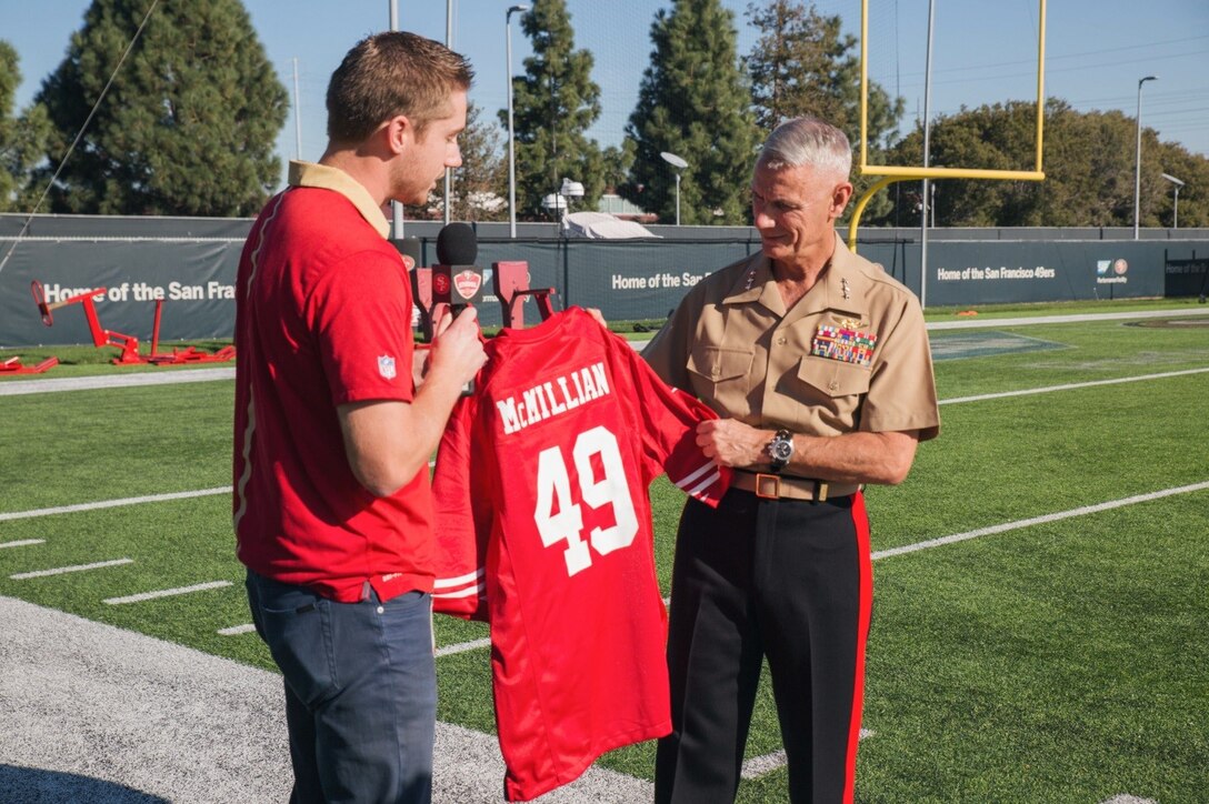 Lieutenant General Rex C. McMillian, commander of Marine Forces Reserve and Marine Forces North, is presented a personalized jersey by Joe Fann, team reporter for the 49ers, at Levi Stadium, Nov. 4, 2016. McMillian was invited to observe a 49ers’ practice session in preparation for Sunday’s “Salute to Service” game against the New Orleans Saints at Levi’s Stadium. The half-time show of Sunday’s game will recognize the Marine Forces Reserve Centennial. Today, approximately 500 Reserve Marines are providing fully integrated operational support to Fleet and Combatant Commanders around the world. For more information on the history and heritage of Marine Forces Reserve as well as current Marine stories and upcoming Centennial events, please visit www.marines.mil/usmcr100. (U.S. Marine Corps photo by Lance Cpl. Dallas Johnson)