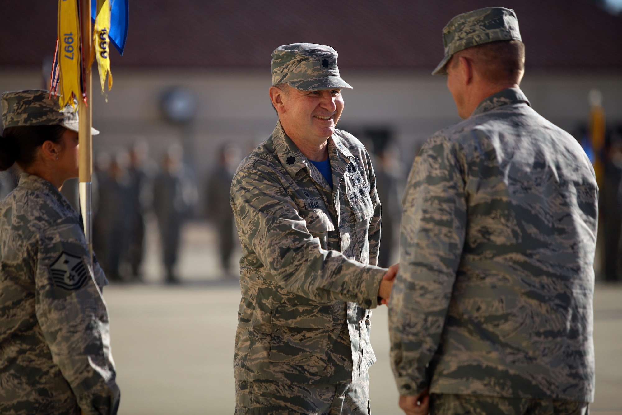 Lt. Col. Blake LaMar shakes hands with 163d Attack Wing commander, Col. Dana Hessheimer, during an assumption of command ceremony as he accepts command of the 163d Maintenance Group during a wing formation Oct. 1, 2016, at March Air Reserve Base, California. (Air National Guard photo by Airman 1st Class Crystal Housman)