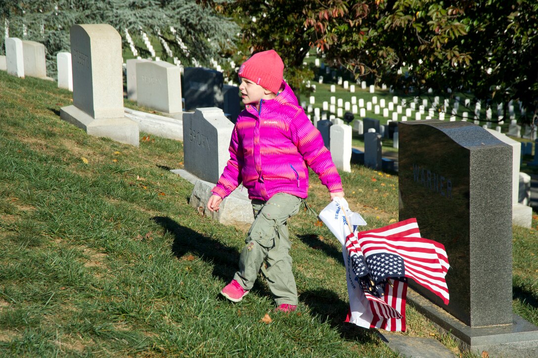 A member of a Coast Guard family takes part in the Flags Across America event at Arlington National Cemetery, Arlington, Va., Nov. 5, 2016. Coast Guard photo by Petty Officer 2nd Class Lisa Ferdinando
