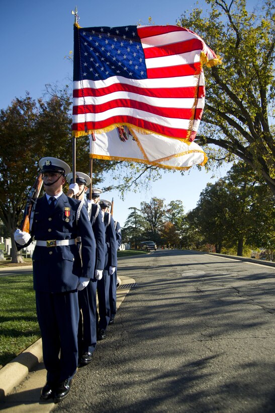 The Coast Guard Honor Guard takes part in the annual Flags Across America event at Arlington National Cemetery, Arlington, Va., Nov. 5, 2016. Coast Guard members, their friends and families placed American and Coast Guard flags at the graves of Coast Guardsmen to honor the service and sacrifice of those who have worn the uniform. Coast Guard photo by Petty Officer 2nd Class Lisa Ferdinando