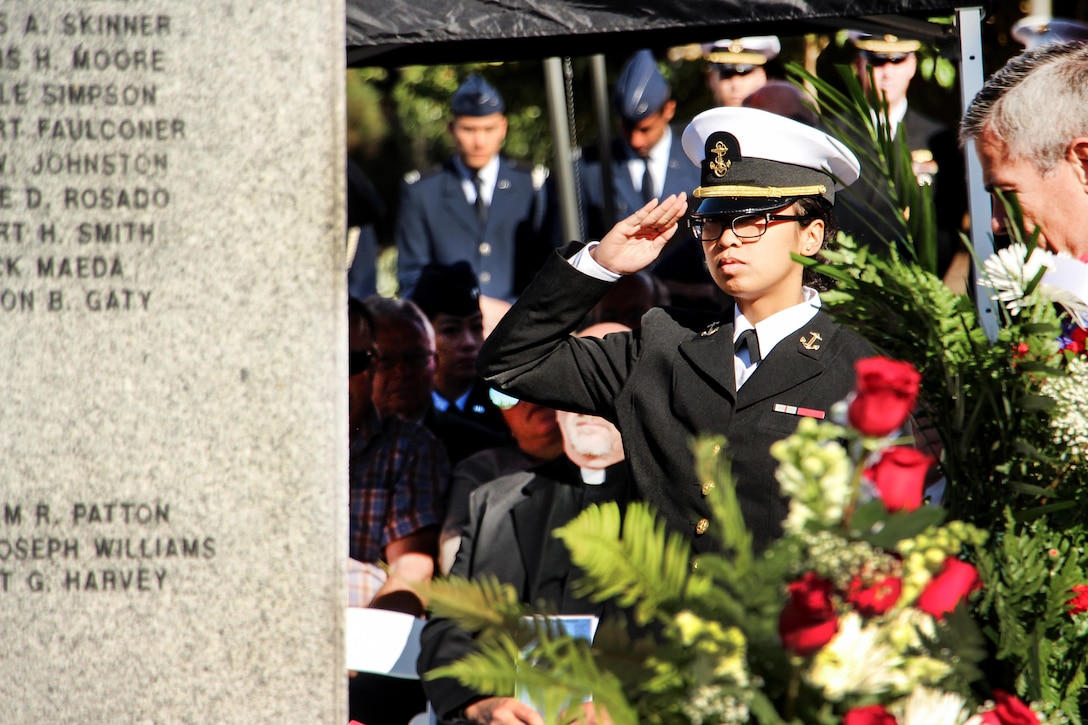 A midshipman assigned to Navy ROTC San Diego salutes after laying a wreath at the War Memorial on Aztec Green at San Diego State University, San Diego, Nov. 4, 2016. Navy photo by Lt. Matthew Stroup