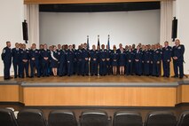 Col. Joe McFall, 52nd Fighter Wing commander, right, and Chief Master Sgt. Edwin Ludwigsen, 52nd FW command chief, left, pose with 52nd FW Airmen during a Community College of the Air Force graduation ceremony at the base theater at Spangdahlem Air Base, Germany, Nov. 4, 2016. The Airmen earned their associates degrees in various career-related fields as part of their completion from the largest community college in the United States. (U.S. Air Force photo by Staff Sgt. Joe W. McFadden/Released)