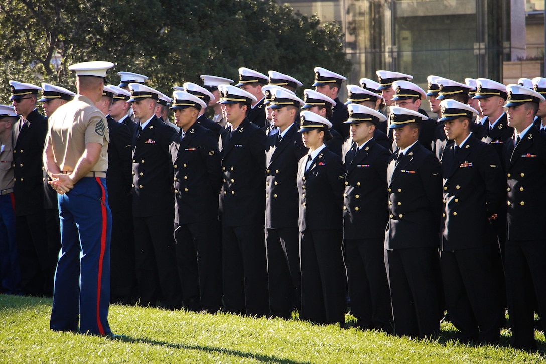 A Marine Corps non-commissioned officer reviews a formation of midshipmen assigned to Naval ROTC San Diego before a wreath-laying ceremony at the War Memorial on Aztec Green at San Diego State University, San Diego, Nov. 4, 2016. Navy photo by Lt. Matthew Stroup
