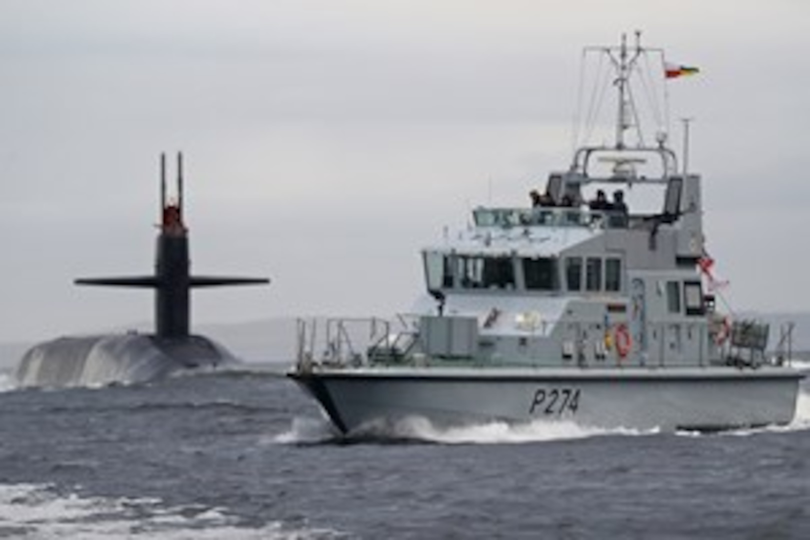 The ballistic missile submarine USS Tennessee (SSBN 734) arrives at Her Majesty's Naval Base Clyde, Faslane, Scotland, escorted by HMS Tracker (P274), for a regularly scheduled port visit, Oct. 7, 2016. The event follows the visit of the USS Wyoming to Faslane in September 2015, and highlights the close relationship shared by the United States and United Kingdom to support global security objectives with highly trained, interoperable strategic forces. The U.S. routinely and visibly demonstrates commitment to allies through forward presence and operations of strategic forces. (Photo courtesy of LA(Phot) Will Haigh)