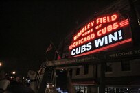The marquee outside of Major League Baseball's Chicago Cubs Wrigley Field lights up with CUBS WIN! following their win in Game 7 of the World Series vs Cleveland Indians, Nov. 2, 2016. Local Army Reserve Soldiers were amongst thousands corralled around Wrigley Field awaiting a hopeful win from the Cubs.
(Photo by Master Sgt. Anthony L. Taylor)