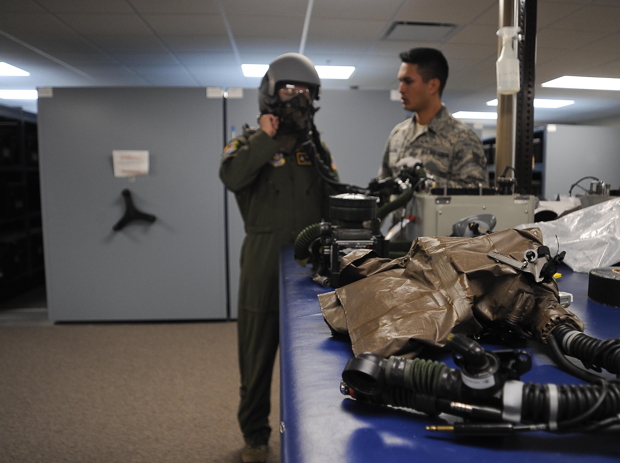 Staff Sgt. Matthew Walters, an aircrew flight equipment technician with the 6th Operations Support Squadron, fits an aircrew member for a helmet at MacDill Air Force Base, Fla., Nov. 2, 2016.  Helmets must be tested to ensure proper fitting. (U.S. Air Force photo by Airman 1st Class Mariette Adams)