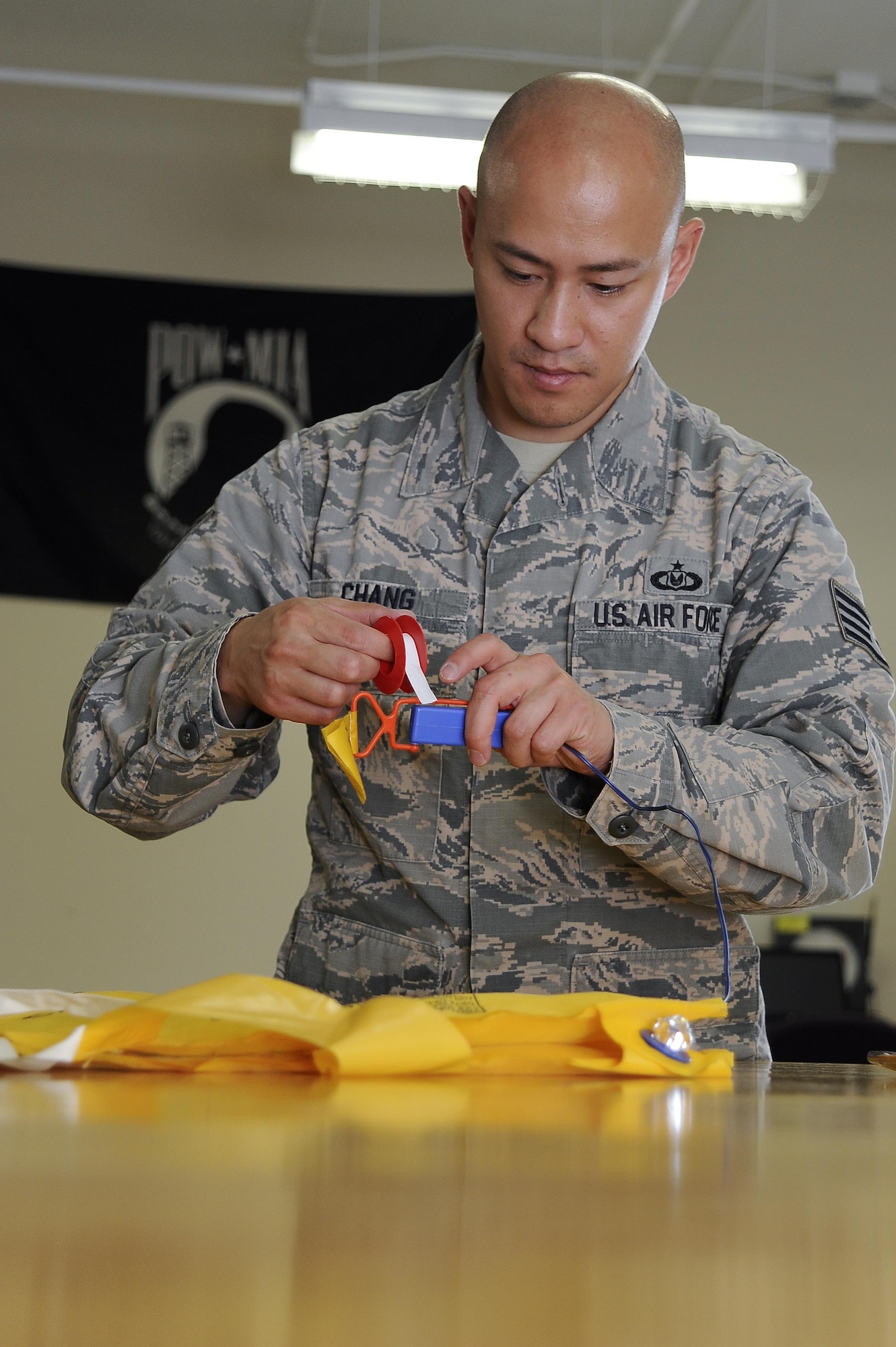 Staff Sgt. Leader Chang, an aircrew flight equipment (AFE) technician with the 6th Operations Support Squadron, inspects  aircraft life vests to ensure mission readiness at MacDill Air Force Base, Fla., Nov. 2, 2016. The flightline section of AFE is responsible for the equipment aboard the aircraft. (U.S. Air Force photo by Airman 1st Class Mariette Adams)