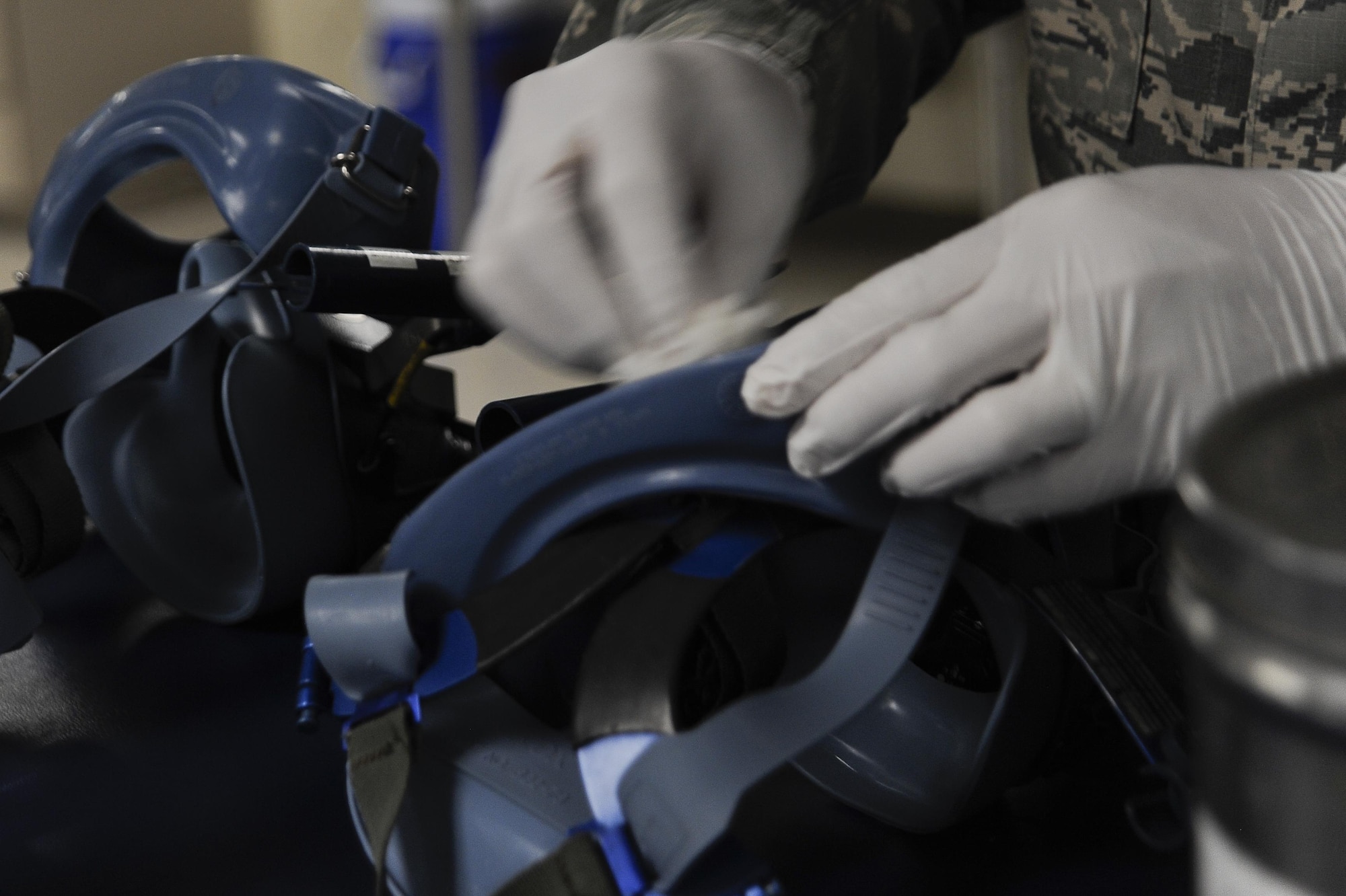 An aircrew flight equipment Airman inspects and cleans a quick don mask at MacDill Air Force Base, Fla., Nov. 2, 2016. Aircrew flight equipment Airmen inspect equipment based on inspection cycles, which requires certain items to be inspected periodically based on their technical orders. (U.S. Air Force photo by Airman 1st Class Mariette Adams)