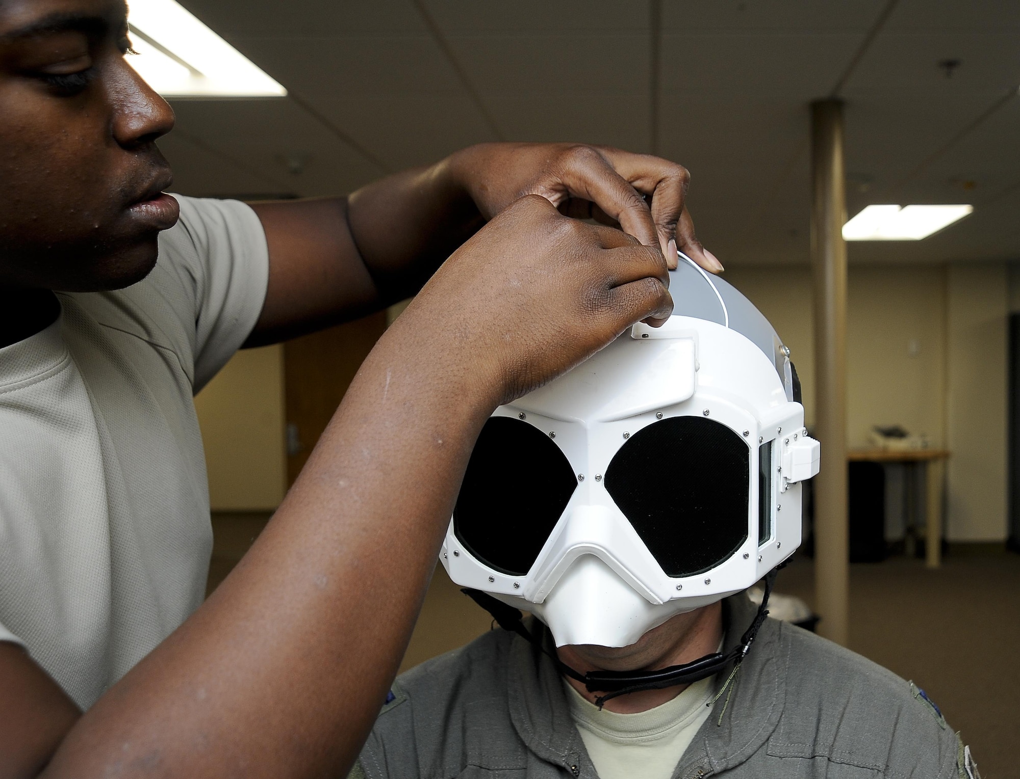 Staff Sgt. James Sherrell, an aircrew flight equipment technician with the 6th Operations Support Squadron, fits goggles to Capt. Ryan Jahnke, a KC-135 Stratotanker pilot with the 91st Air Refueling Squadron, at MacDill Air Force Base, Fla., Nov. 2, 2016. Aircrew flight equipment inspects and maintains equipment for about 130 active duty crew members. (U.S. Air Force photo by Airman 1st Class Mariette Adams)