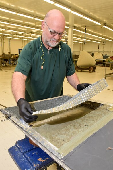 Michael Potter, 553rd Commodities Maintenance Squadron composite fabricator, places a section of aluminum honeycomb in to place on a section of B-1B flight control surface being repaired at the Oklahoma City Air Logistics Complex, July 25, 2016, Tinker Air Force Base, Okla. The 553rd CMMXS manufactures and maintains components for KC-135, B-1B, B-52H, E-3 and E-6 aircraft.  (U.S. Air Force photo/Greg L. Davis)