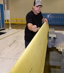 Brett Smith, 553rd Commodities Maintenance Squadron composite fabricator, uses a tap to locate weak points which need repair on a B-1B wing leading edge being inspected and repaired at the Oklahoma City Air Logistics Complex, July 25, 2016, Tinker Air Force Base, Okla. The 553rd CMMXS manufactures and maintains components for KC-135, B-1B, B-52H, E-3 and E-6 aircraft.  (U.S. Air Force photo/Greg L. Davis)
