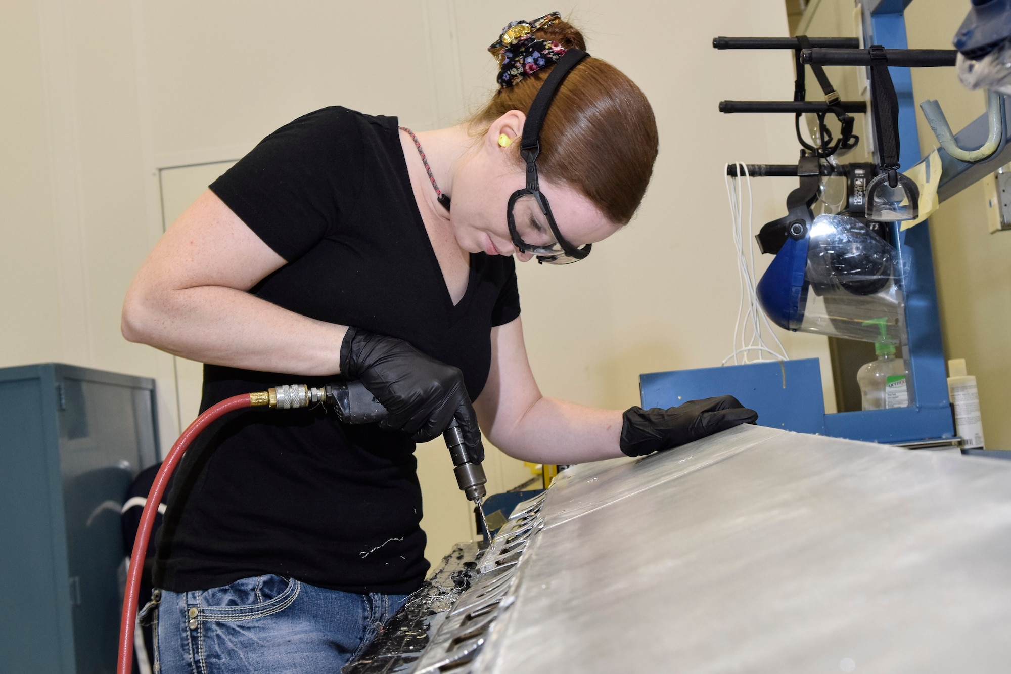 Sarah Holshouser, 553rd Commodities Maintenance Squadron composite fabricator, drills out rivets on a KC-135 aileron she is overhauling at the Oklahoma City Air Logistics Complex, July 25, 2016, Tinker Air Force Base, Okla. The 553rd CMMXS manufactures and maintains components for KC-135, B-1B, B-52H, E-3 and E-6 aircraft.  (U.S. Air Force photo/Greg L. Davis)