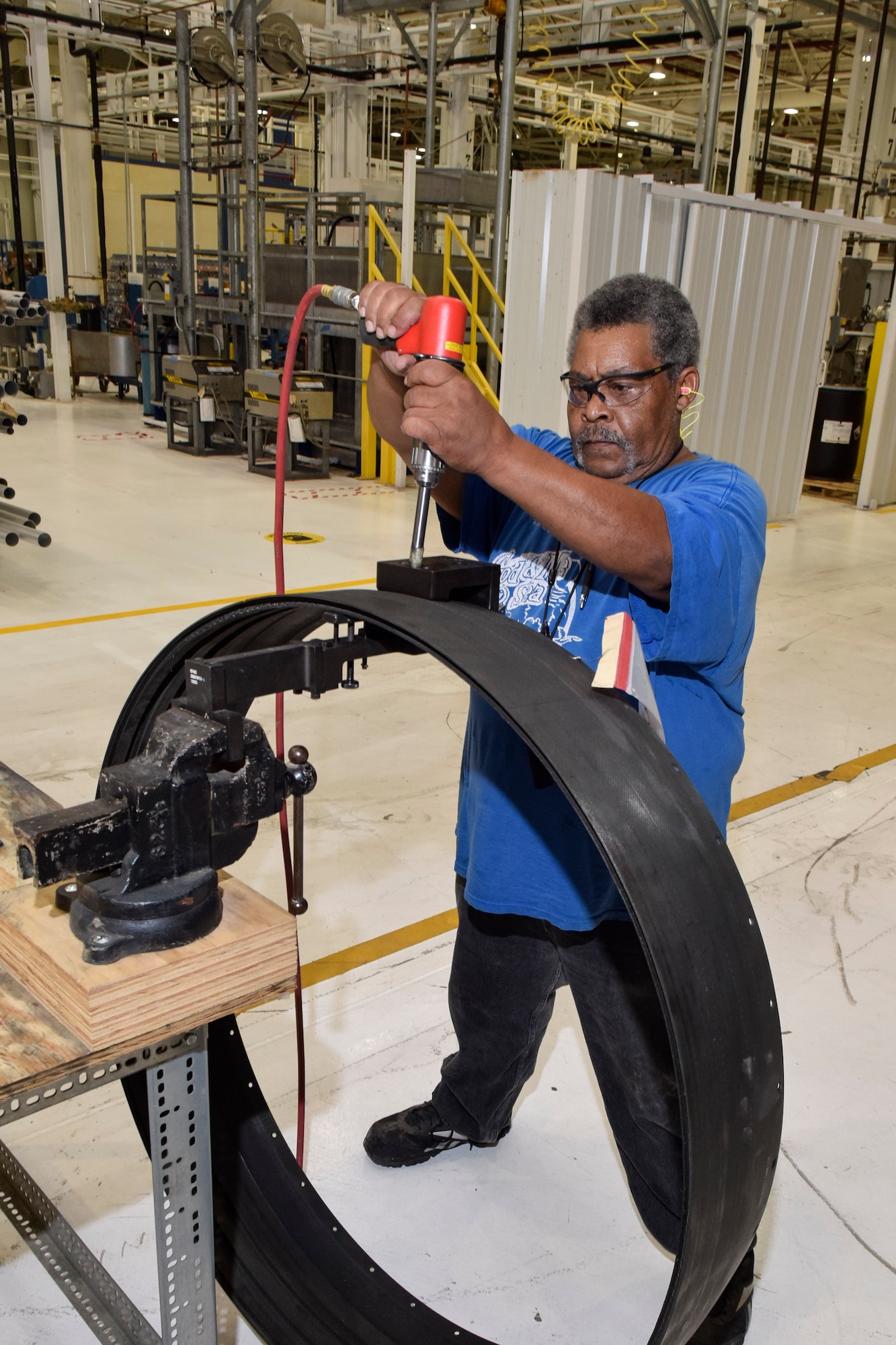 Tony Lightner, 553rd Commodities Maintenance Squadron composite fabricator, uses a jig and hand-held drill to create a hole in a jet engine shroud being modified at the Oklahoma City Air Logistics Complex, July 25, 2016, Tinker Air Force Base, Okla. The 553rd CMMXS manufactures and maintains components for KC-135, B-1B, B-52H, E-3 and E-6 aircraft.  (U.S. Air Force photo/Greg L. Davis)