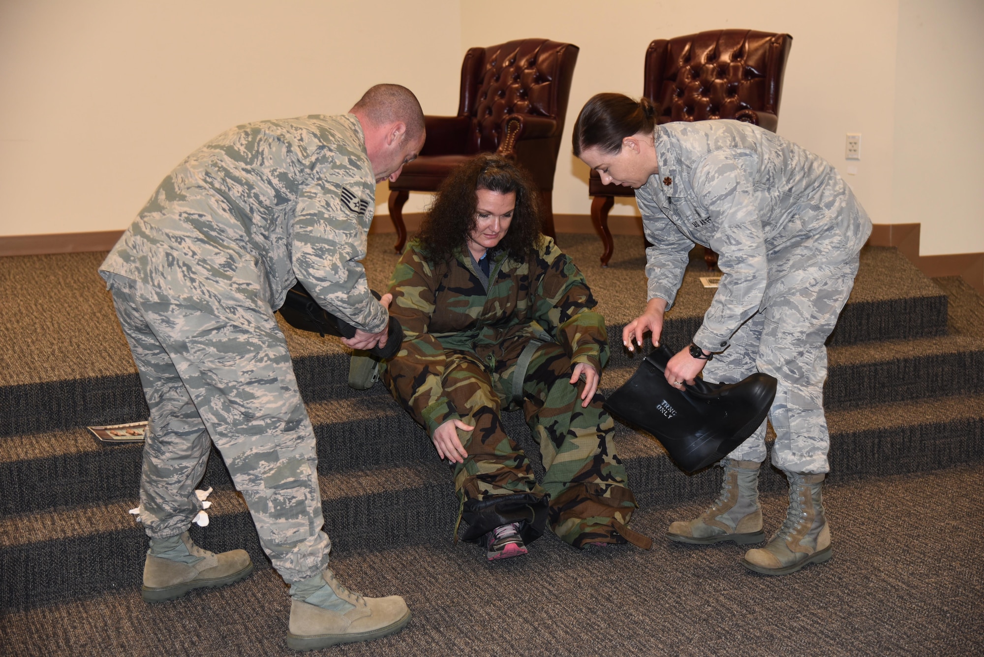 Bethany Butler, from Navy Federal Credit Union, volunteers to put on a chemical warfare suit during a demonstration at the 403rd Wing Employer Day Nov. 5. The employers received a flight, tour and demonstrations of the different jobs and training that their Air Force Reserve employees do when performing military service. (U.S. Air Force photo/Master Sgt. Jessica Kendziorek) 