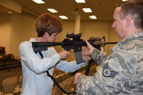 Staff Sgt. Roger Wade, 403rd Security Forces Squadron security forces journeyman, shows the civilian employers the proper way to hold a M-4 rifle during the 403rd Wing Employer Day Nov. 5. The employers received a flight, tour and demonstrations of the different jobs and training that their Air Force Reserve employees do when performing military service. (U.S. Air Force photo/Master Sgt. Jessica Kendziorek) 