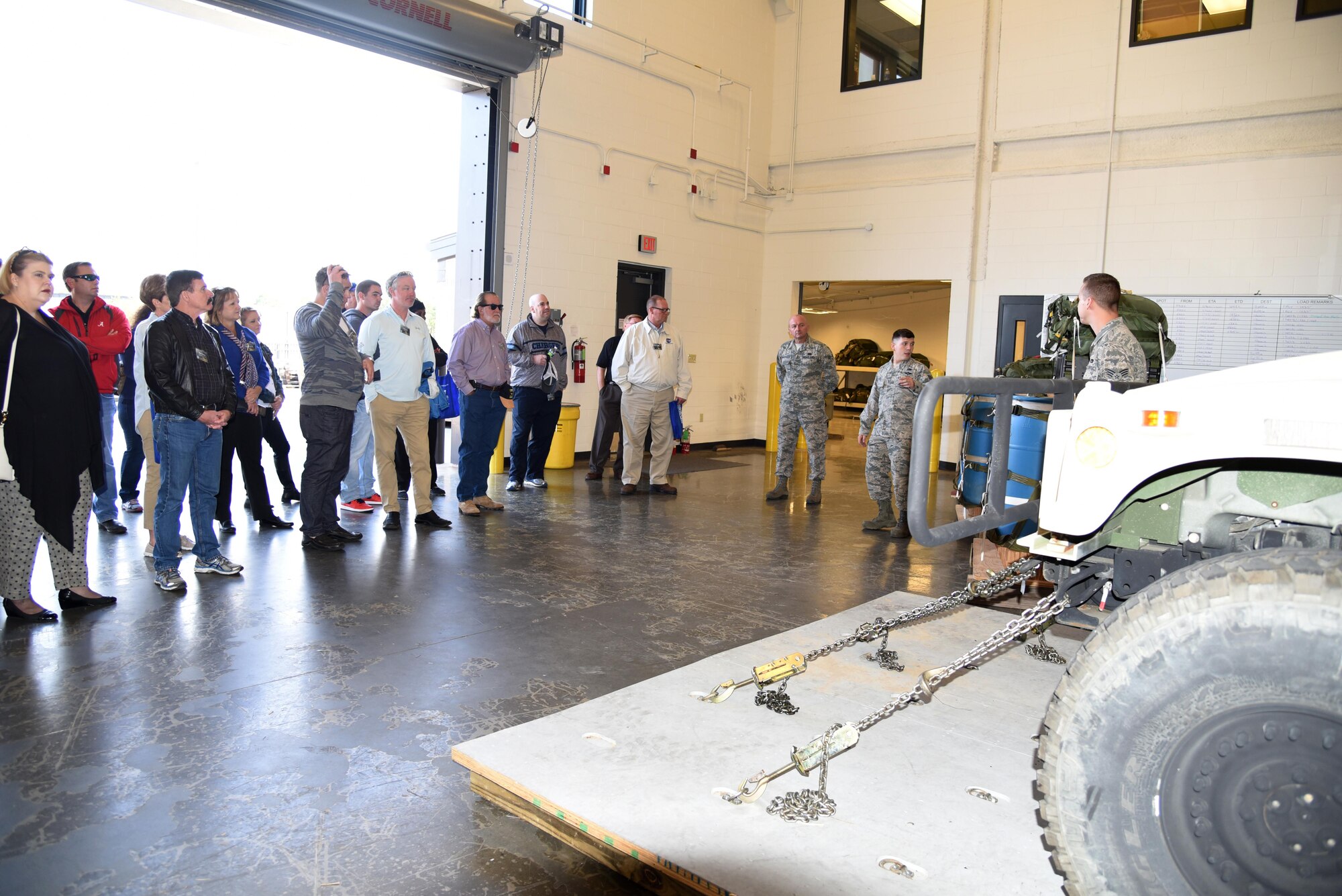 Staff Sgt. Anthony Gaston and Senior Airman Bret Christofferson, 41st Aerial Port Squadron air transportation specialists, brief the employers about the 41st APS during the 403rd Wing Employer Day Nov. 5. The employers received a flight, tour and demonstrations of the different jobs and training that their Air Force Reserve employees do when performing military service. (U.S. Air Force photo/Master Sgt. Jessica Kendziorek) 