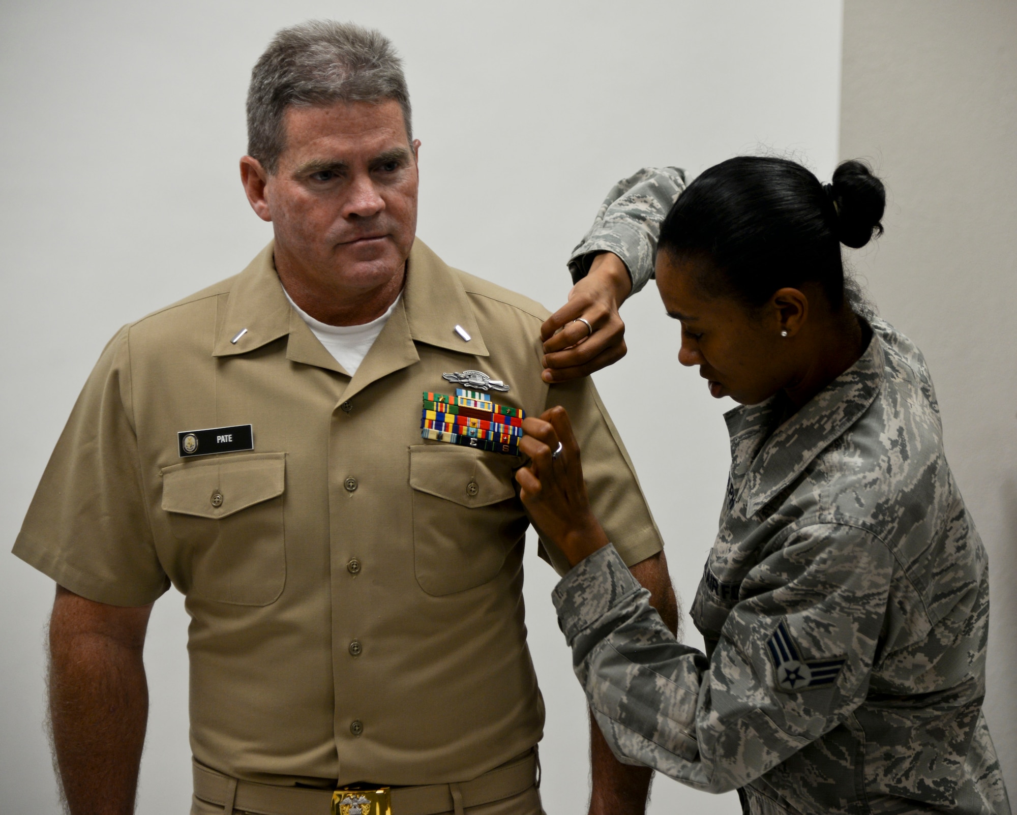 Senior Airman Jenay Randolph, right, a public affairs (PA) photojournalist assigned to the 6th Air Mobility Wing, assists a customer during an official photo appointment in the photo lab at MacDill Air Force Base, Fla., Nov. 4, 2016. MacDill PA Airmen provide photographic support to more than 18,000 joint service personnel, as well as off-base Reserve Officer Training Corps, Reserve and Army National Guard units who have established support agreements with MacDill. (U.S. Air Force photo by Senior Airman Vernon L. Fowler Jr.)