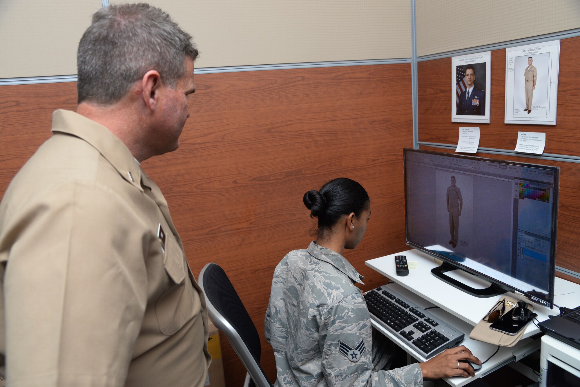 Senior Airman Jenay Randolph, right, public affairs photojournalist assigned to the 6th Air Mobility Wing (AMW), edits an official photo in the photo lab at MacDill Air Force Base, Fla., Nov. 4, 2016. The Airmen in the 6th AMW photo lab are trained to know the uniform and photo standards for each U.S. service branch. (U.S. Air Force photo by Senior Airman Vernon L. Fowler Jr.)