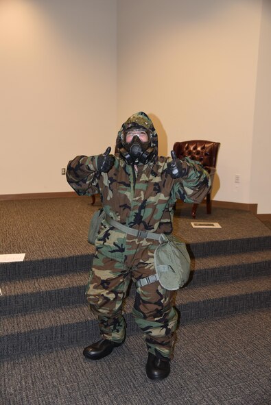 Bethany Butler, from Navy Federal Credit Union, volunteers to put on a chemical warfare suit during a demonstration at the 403rd Wing Employer Day Nov. 5. The employers received a flight, tour and demonstrations of the different jobs and training that their Air Force Reserve employees do when performing military service. (U.S. Air Force photo/Master Sgt. Jessica Kendziorek) 