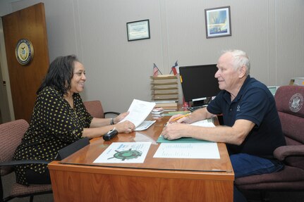Senior Master Sgt. retired Ramona Orum, left, is consulted by Chief Master Sgt. retired Jan Lindgren, Retiree Activities Office director at Joint Base San Antonio-Randolph, Oct. 31.  The RAO serves as an information center for space-available travel, Tricare, base services, offering referrals for financial-assistance and pay matters; and providing literature on retirement issues.  