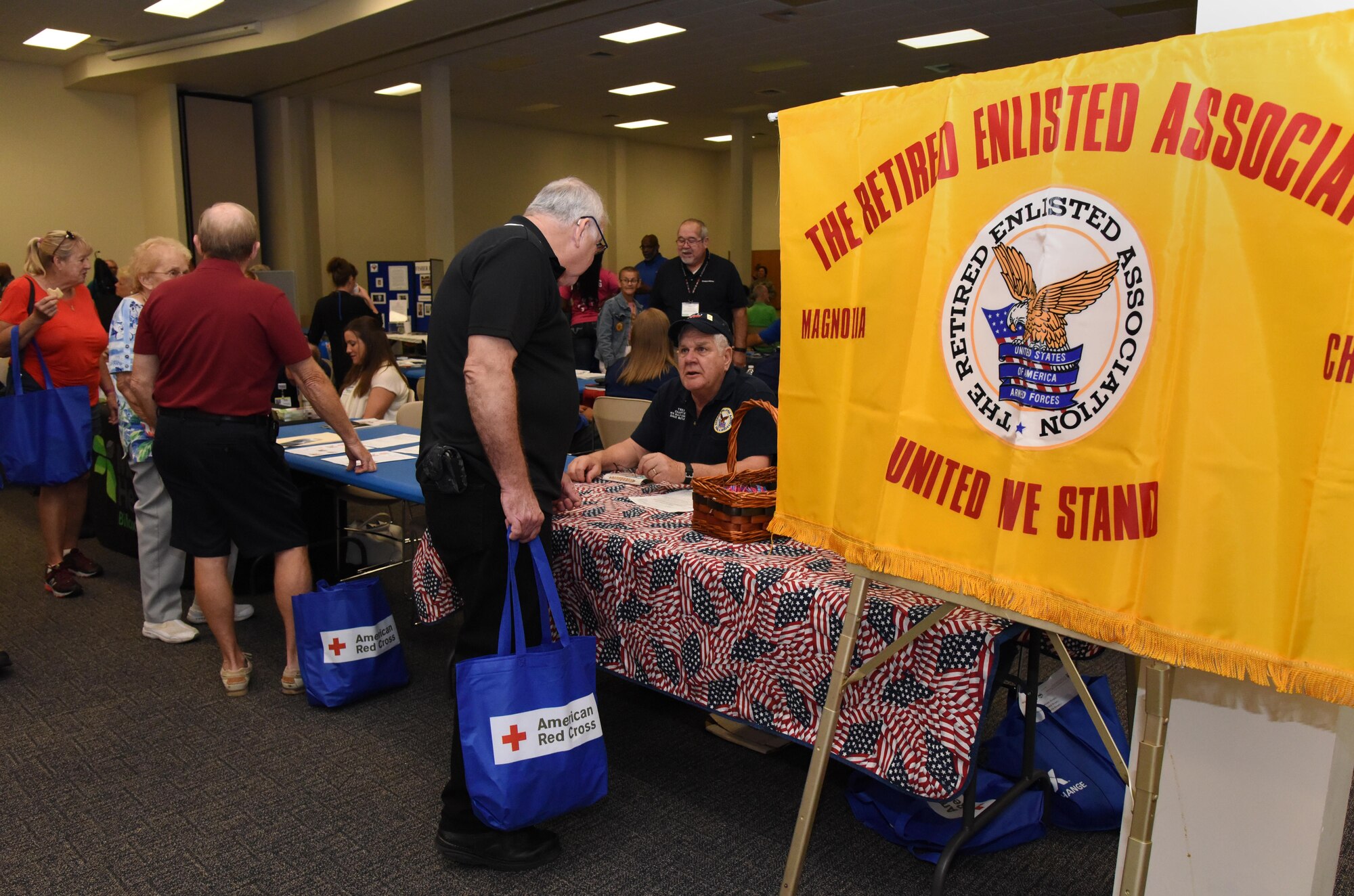 U.S. Army retired Capt. Bradley Pierron receives organization information from retired Senior Master Sgt. Dave Butler, Retired Enlisted Association member, during Retiree Appreciation Day at the Roberts Consolidated Aircraft Maintenance Facility Nov. 4, 2016, on Keesler Air Force Base, Miss. The annual event, sponsored by the Keesler Retiree Activities Office, included more than 20 displays with information pertinent to retirees and a free lunch. (U.S. Air Force photo by Kemberly Groue/Released)