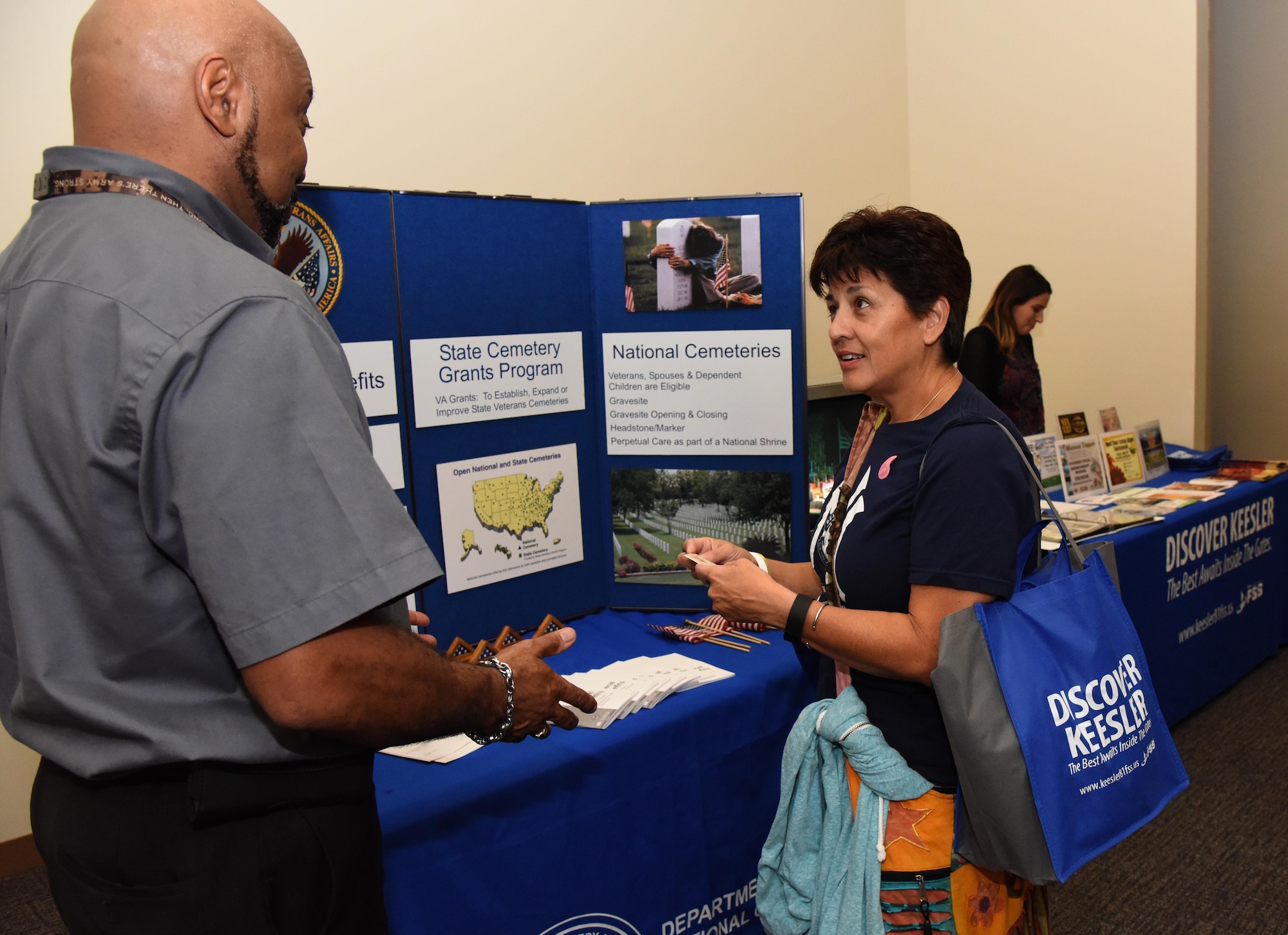 Oliver Conerly, Biloxi National Cemetery program support assistant, provides information to retired Master Sgt. Martha Prieto-Moreno, 81st Medical Group customer relations director, during Retiree Appreciation Day at the Roberts Consolidated Aircraft Maintenance Facility Nov. 4, 2016, on Keesler Air Force Base, Miss. The annual event, sponsored by the Keesler Retiree Activities Office, included more than 20 displays with information pertinent to retirees and a free lunch. (U.S. Air Force photo by Kemberly Groue/Released)