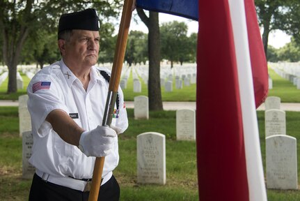 U.S. Air Force (Ret.)  Lt. Col. Michael P. Hoffman, Fort Sam Houston National Cemetery Memorial Service Detachment volunteer, helps provide a proper military burial at FSHNC June 10, 2016. The MSD performed services for 18 funerals June 10, breaking a previous single day record of 16. The Fort Sam Houston MSD has performed more than 32,000 services since its inception in 1991.