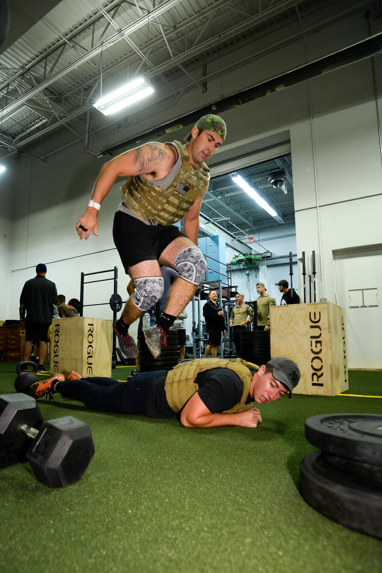 Capt. Nate Demers jumps over Senior Airman Jesse Citrin during the EOD 131 Memorial Workout at Hill Air Force Base, Nov. 4, 2016. Demers and Citrin are assigned to the 775th Explosive Ordnance Disposal Flight. (U.S. Air Force photo by R. Nial Bradshaw) (U.S. Air Force photo by R. Nial Bradshaw)