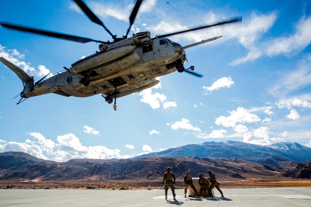 A CH-53E Super Stallion, with Marine Heavy Helicopter Squadron 466, hovers to pick up a 500-gallon drum of water from U.S. Marines with Combat Logistics Battalion 15, 1st Marine Logistics Group and 3rd Battalion, 4th Marine Regiment, 1st Marine Division during a Helicopter Support Team drill at Mountain Warfare Training Center, Bridgeport, Calif., Oct. 25, 2016. The drum was taken into the Sierra Mesa Mountains to support Marines who are conducting field operations during Mountain Exercise 6-16. (U.S. Marine Corps photo by Lance Cpl. Adam Dublinske)