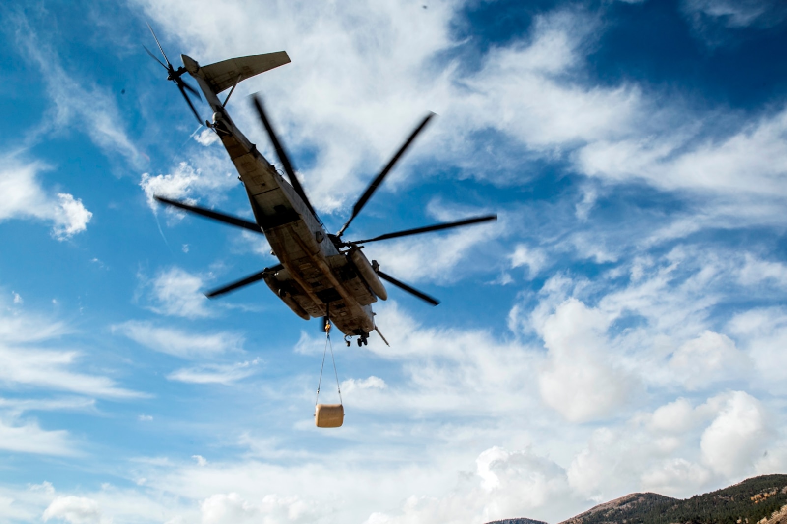 A CH-53E Super Stallion, with Marine Heavy Helicopter Squadron 466, transports a 500-gallon drum of water to Marines who are conducting field operations in the Sierra Mesa Mountains, Calif., Oct. 25, 2016. The drum supported Marines who participating during Mountain Exercise 6-16. (U.S. Marine Corps photo by Lance Cpl. Adam Dublinske)