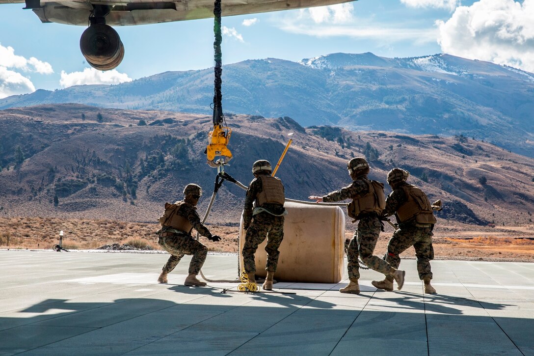 U.S. Marines with Combat Logistics Battalion 15, 1st Marine Logistics Group, and 3rd Battalion, 4th Marine Regiment, 1st Marine Division, strap a 500-gallon drum of water to a CH-53E Super Stallion, with Marine Heavy Helicopter Squadron 466, during a Helicopter Support Team drill at Mountain Warfare Training Center, Bridgeport, Calif., Oct. 25, 2016. The drum was taken into the Sierra Mesa Mountains to support Marines who are conducting field operations during Mountain Exercise 6-16. (U.S. Marine Corps photo by Lance Cpl. Adam Dublinske)