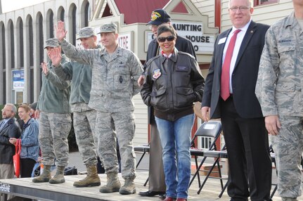 Maj. Gen. Clinton E. Crosier (on stage, third from left), U.S. Strategic Command (USSTRATCOM) director of plans and policy; Bellevue Mayor Rita Sanders (third from right); and other leaders from the command, the 55th Wing and the local community observe the 2016 Veteran’s Day Parade in Bellevue, Neb., Nov. 5, 2016. The leaders attended the seventeenth annual parade to support the service members from their respective commands who volunteered to participate and honor U.S. veterans, both past and present.