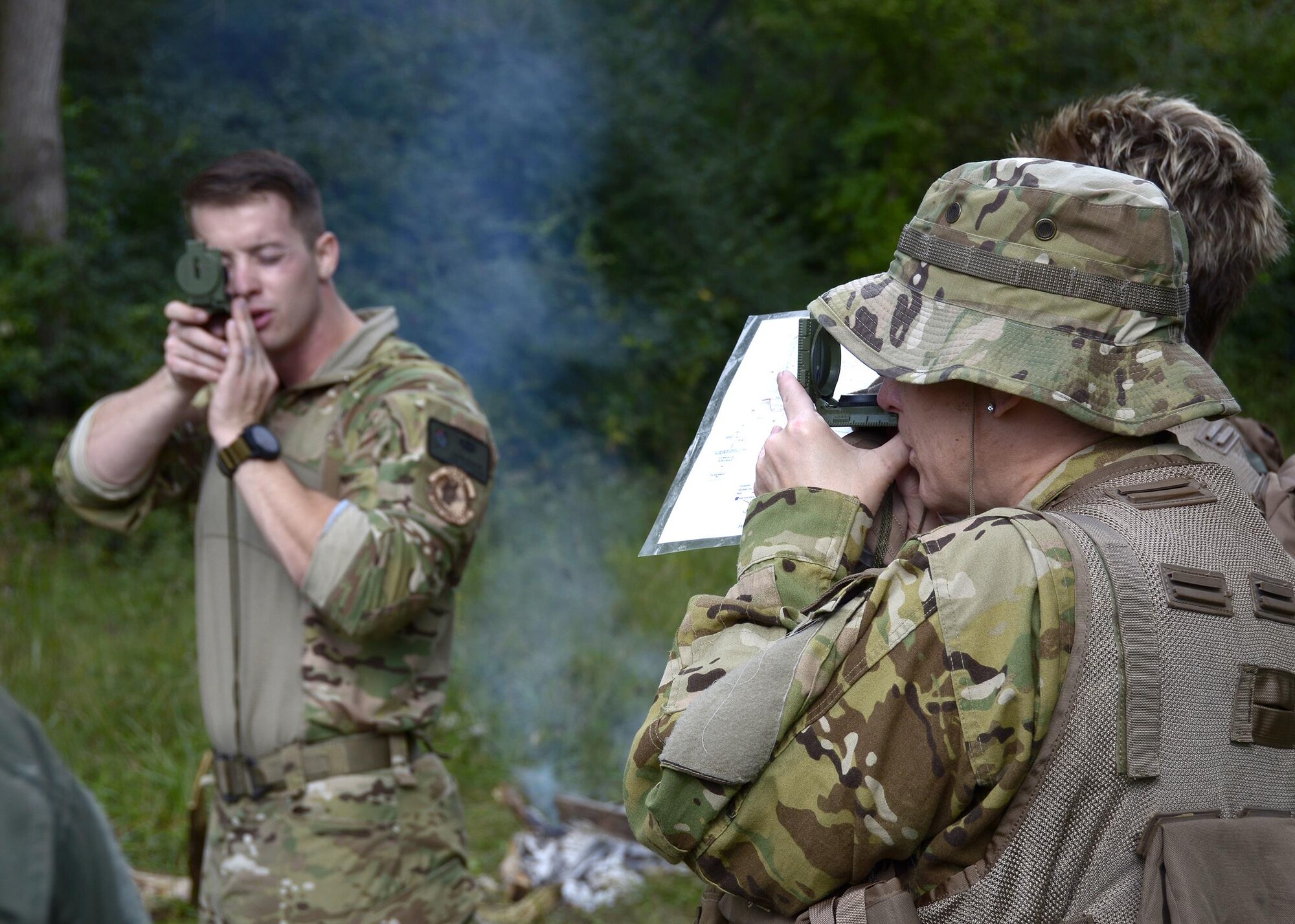 An Airman from the 445th Aeromedical Evacuation Squadron, practices her compass techniques as Staff Sgt. Jacob Nespor, SERE specialist for the 445th Operations Support Squadron, instructs the class during Combat Survival Training Oct. 2nd, 2016, at the Warfighter Training Center here. Compass work was the instruction leading towards land Navigation. (U.S. Air Force photo/Staff Sgt. joel McCullough)