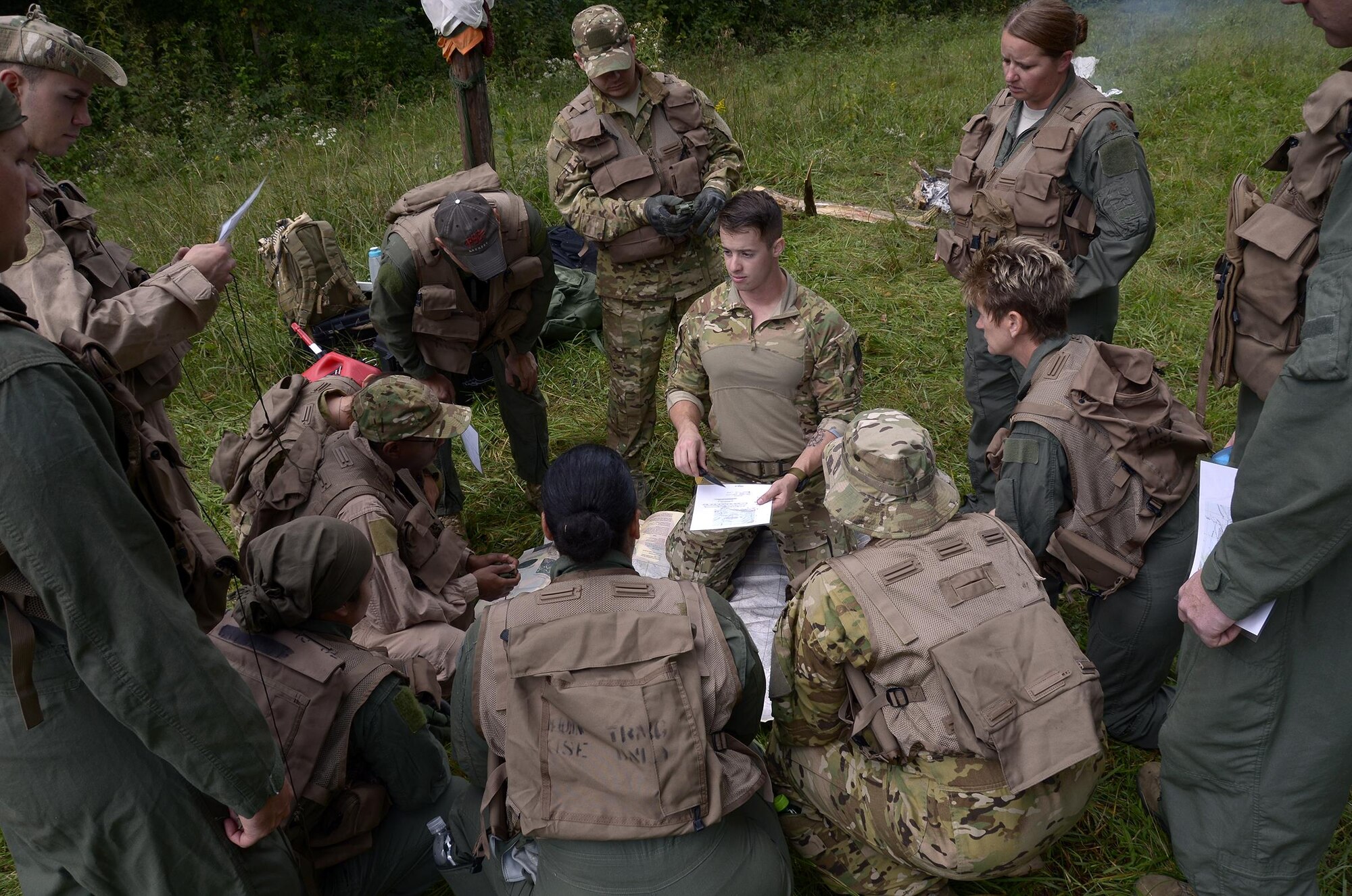 Staff Sgt. Jacob Nespor, SERE specialist for the 445th Operations Support Squadron, listens to a question being asked by an Airman of the 445th Aeromedical Evacuation Squadron during a map usage and reading course Oct. 2nd, 2016, at the Warfighter Training Center here. The course was part of the land navigation portion of the Combat Survival Training. (U.S. Air Force photo/Staff Sgt. Joel McCullough)