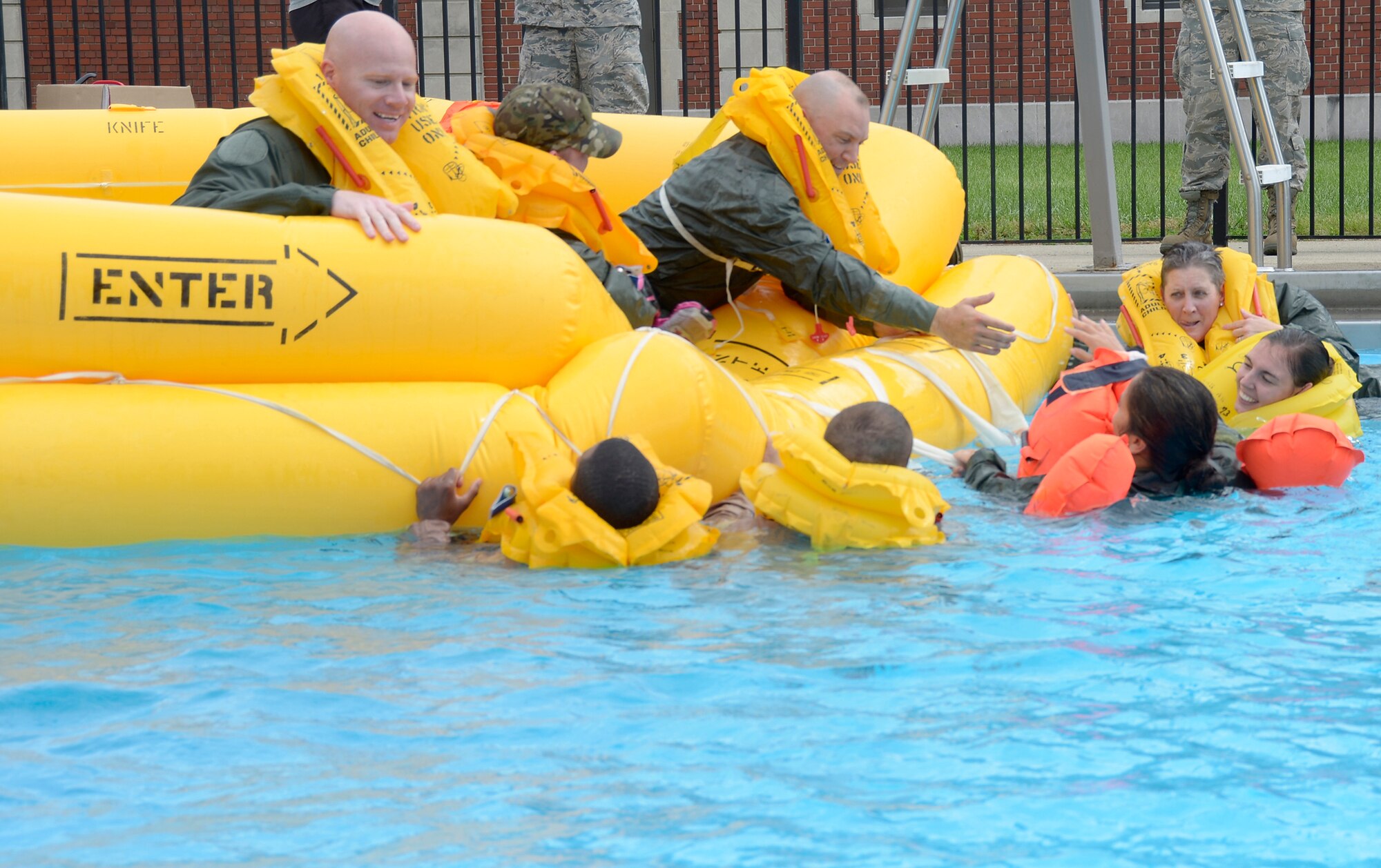 Members of the 445th Aeromedical Evacuation Squadron help each other enter a raft during water survival training Oct. 2, 2016, at Wright-Patterson Air Force Base, Ohio. The Airmen learn to stay calm and help each other in a time of need. (U.S. Air Force photo/Staff Sgt. Joel McCullough)