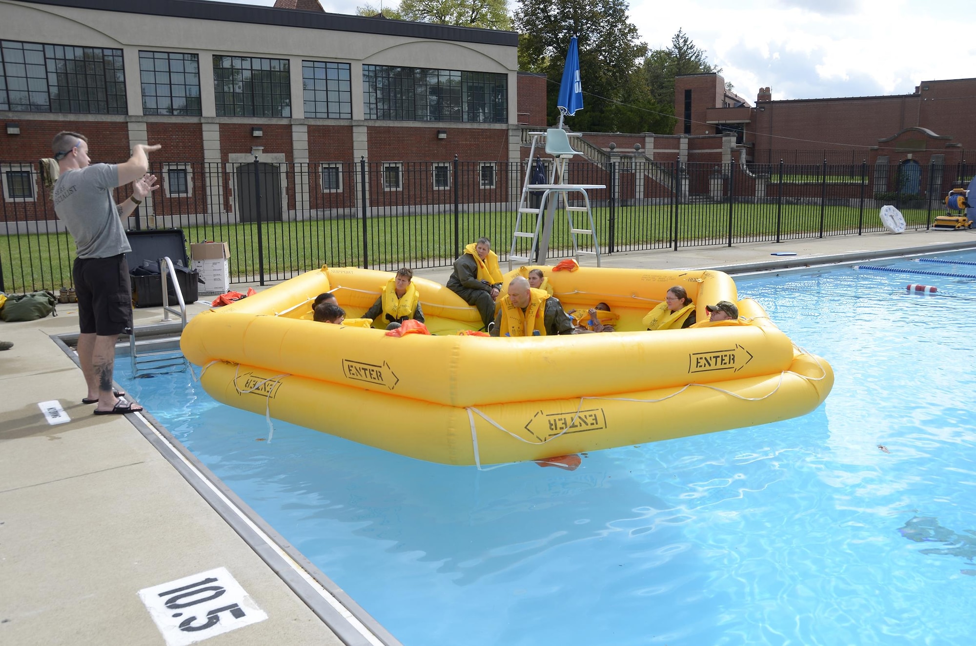 Staff Sgt. Jacob Nespor, SERE specialist for the 445th Operations Support Squadron, instructs members of the 445th Aeromedical Evacuation Squadron during Water Survival Training Oct. 2, 2016, at Wright-Patterson Air Force Base, Ohio. Nespor explained the dos and don’ts while setting up the raft canopy. (U.S. Air Force photo/Staff Sgt. Joel McCullough)