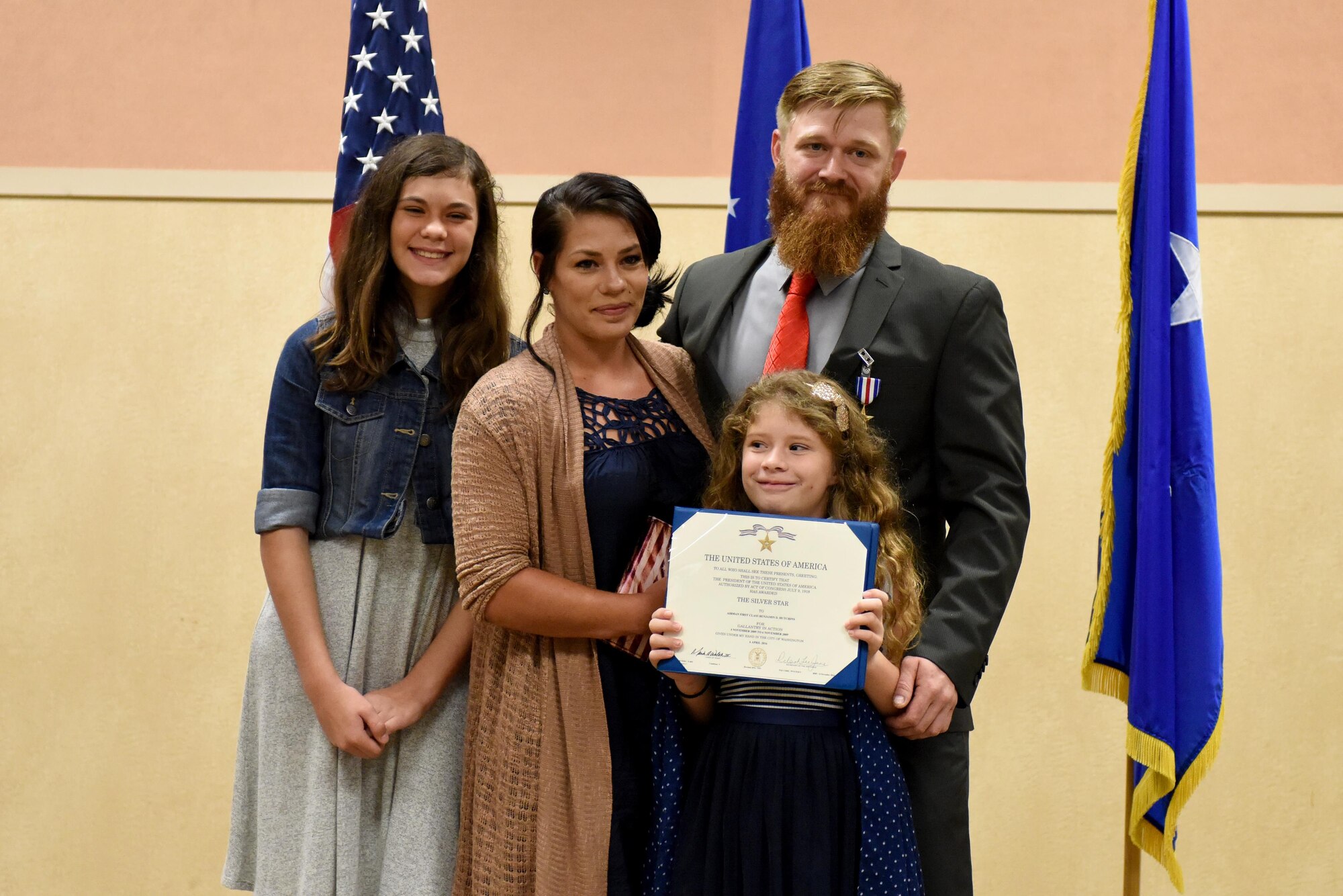 Retired Staff Sgt. Benjamin Hutchins, 18th Air Support Operations Group joint terminal attack controller, and his family pose for a photo during a ceremony where he received the Silver Star Medal, Nov. 4, 2016, at Pope Army Airfield, North Carolina. Hutchins received the Silver Star for attempting to save drowning soldiers in the face of imminent danger during a deployment in 2009 in Bala Murghab, Afghanistan. (U.S. Air Force photo by Airman Miranda A. Loera)