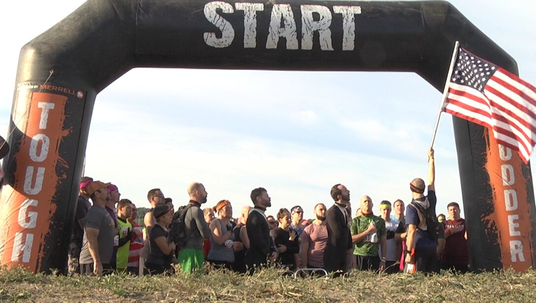 ARLINGTON, Texas - (October 23, 2016) - Motivated Mudders, including members of the 4th Sustainment Command (Expeditionary), stand together to sing the National Anthem at the starting line of the Dallas/Fort Worth Tough Mudder 2016.  (U.S. Army Reserve Photo by Maj. Brandon R. Mace)