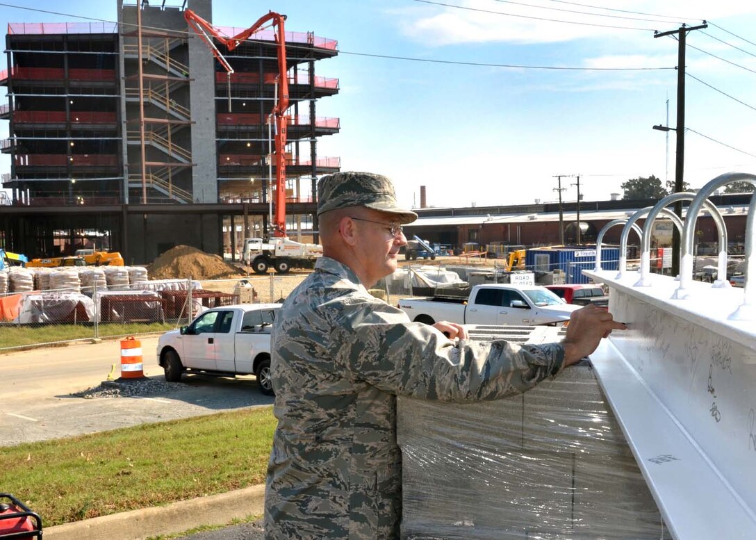 Defense Logistics Agency Aviation Commander Air Force Brig. Gen. Allan Day signs the final structural beam that will be placed on Phase I of the new DLA Aviation Operations Center at Defense Supply Center Richmond, Virginia, in a “topping off” ceremony held on the construction site Nov. 3, 2016. The beam will go in one of the elevator shafts and finalizes the framing of the building. The Phase I building should be completed and ready for occupancy by DLA Aviation employees between December 2017 and January 2018. 