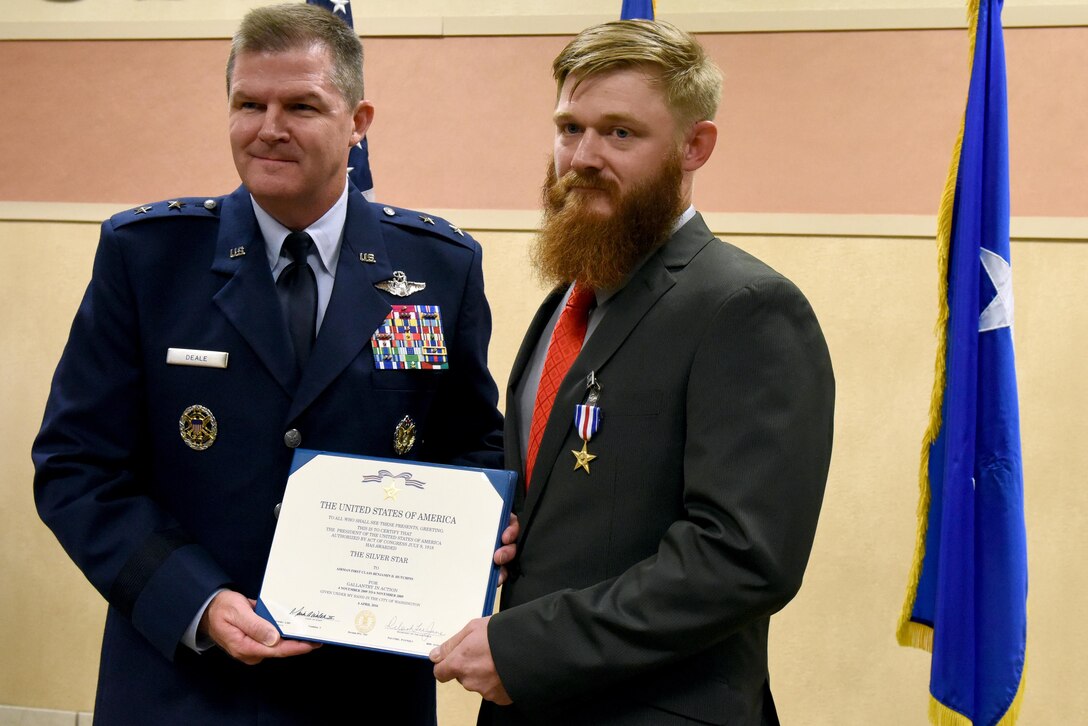 Maj. Gen. Thomas Deale, Air Combat Command director of operations, presents retired Staff Sgt. Benjamin Hutchins, 18th Air Support Operations Group joint terminal attack controller, with the Silver Star Medal during a ceremony, Nov. 4, 2016 at Pope Army Airfield, North Carolina. Hutchins received the medal for his heroic actions during a deployment while assigned to the 504th Expeditionary Air Support Operations Group in Bala Murghab, Afghanistan in 2009. (U.S. Air Force photo by Airman Miranda A. Loera)