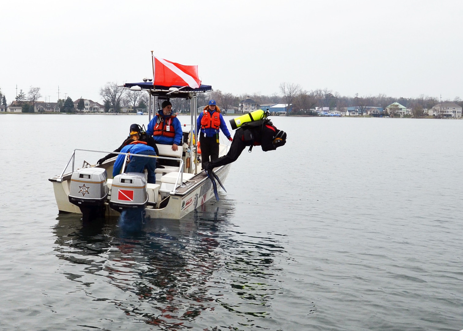 A Kalamazoo County, Michigan, Sheriff's Department diver goes over the side while getting familiar with a boat acquired through the Law Enforcement Support Office program.