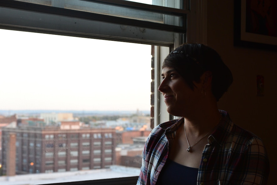 Staff Sgt. Ashleigh Buch, an instructor with the 338th Combat Training Squadron at Offutt Air Force Base, Neb., looks out over the city of Omaha from her apartment Oct. 20, 2016. Buch is the first openly serving transgender Airman to be recommended for a return to flying duties. (U.S. Air Force photo/Senior Airman Rachel Hammes)