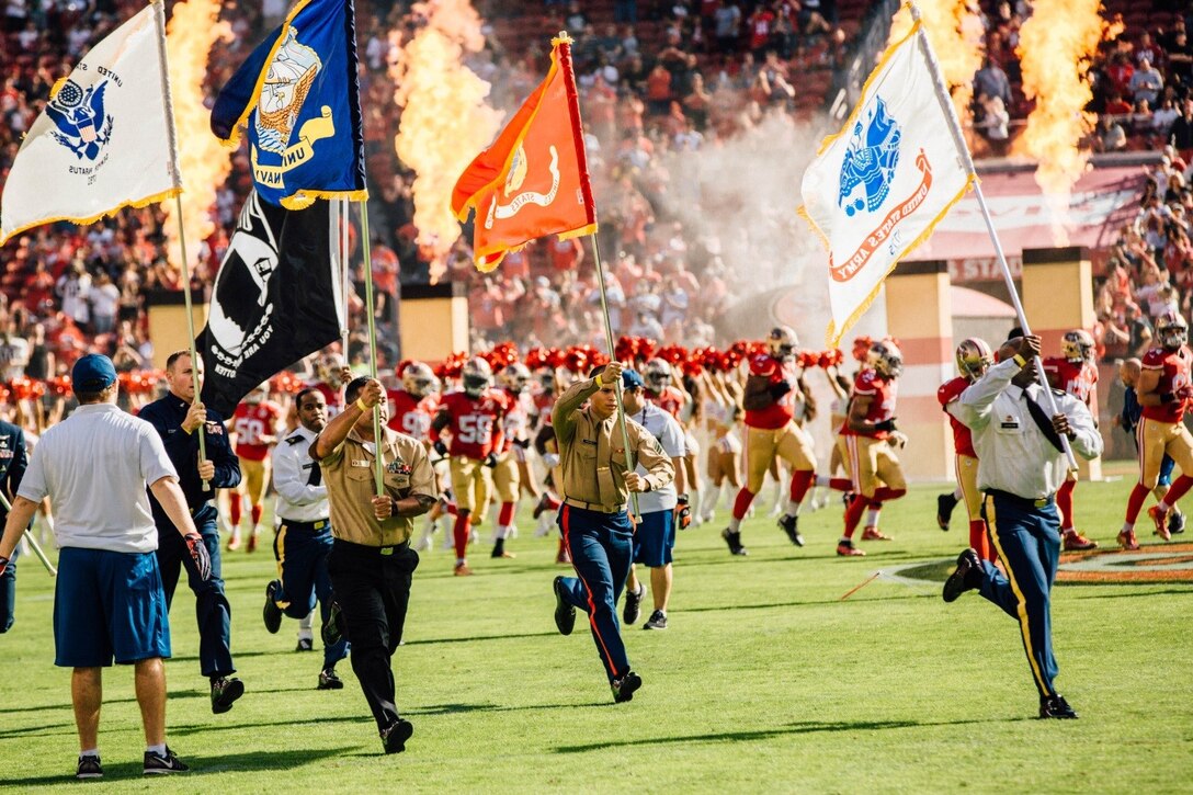 Service members from each military branch lead players of the San Francisco 49ers onto the field before the singing of the national anthem by Captain Skye Martins, public affairs officer for 12th Marine district. The National Football League’s “Salute to Service” highlighted the Marine Forces Reserve Centennial during the 49ers’ game against the New Orleans Saints, Nov. 6, 2016. Today, approximately 500 Reserve Marines are providing fully integrated operational support to Fleet and Combatant Commanders around the world.  For more information on the history and heritage of Marine Forces Reserve as well as current Marine stories and upcoming Centennial events, please visit www.marines.mil/usmcr100. (U.S. Marine Corps photo by Lance Cpl. Dallas Johnson)
