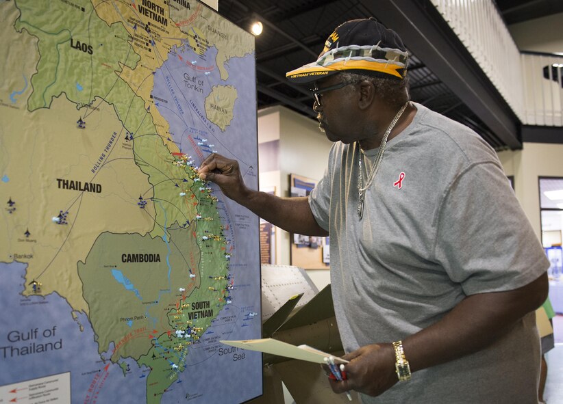A veteran pins the location where he was stationed during the Vietnam War at the Air Force Armament Museum’s Northwest Florida 50th Vietnam War Commemoration Celebration event Nov. 5 at Eglin Air Force Base, Fla. Event activities included a military working dog demonstration, explosive ordnance removal robots, Army Ranger reptile display, a speaker’s panel and an AC-130 tour.  (U.S. Air Force photo/Kristin Stewart)
