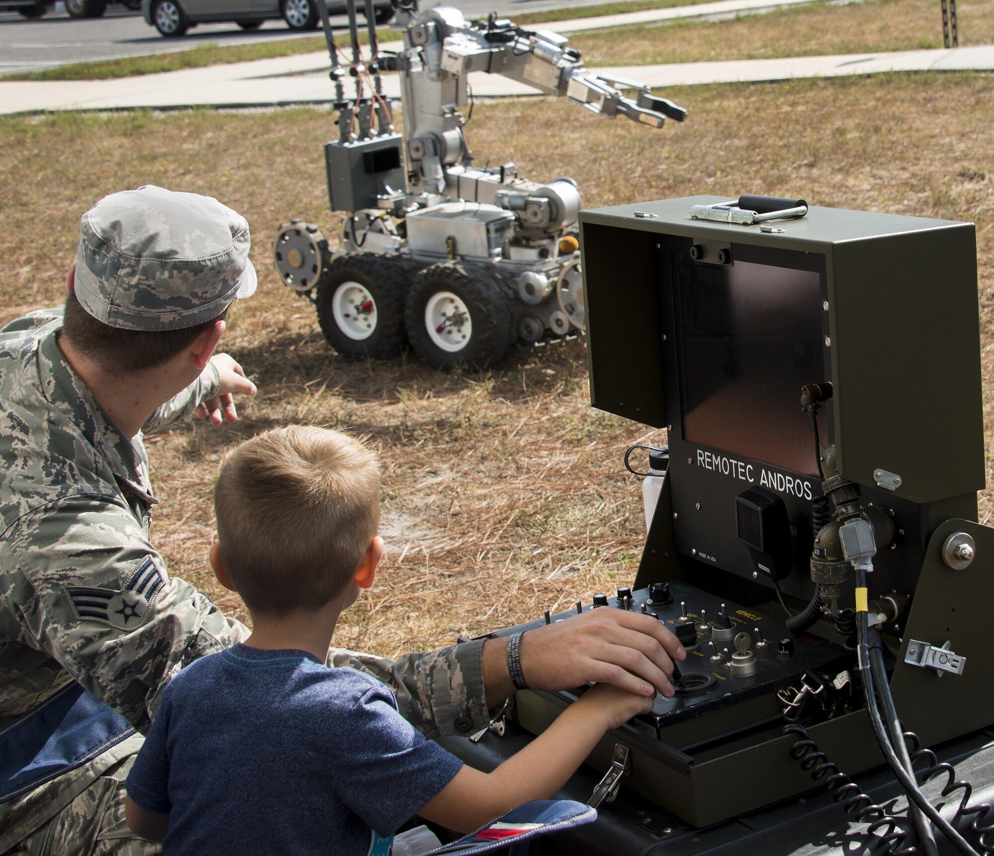 Senior Airman Kyle Riedinger, 96th Civil Engineer Squadron, helps a child control an explosive ordnance disposal robot during a demonstration Nov. 5 at Eglin Air Force Base, Fla. The Air Force Armament Museum hosted the Northwest Florida 50th Vietnam War Commemoration Celebration event to honor veterans’ service and sacrifices.  Event activities included a military working dog demonstration, explosive ordnance removal robots, Army Ranger reptile display, a speaker’s panel and an AC-130 tour. (U.S. Air Force photo/Kristin Stewart)