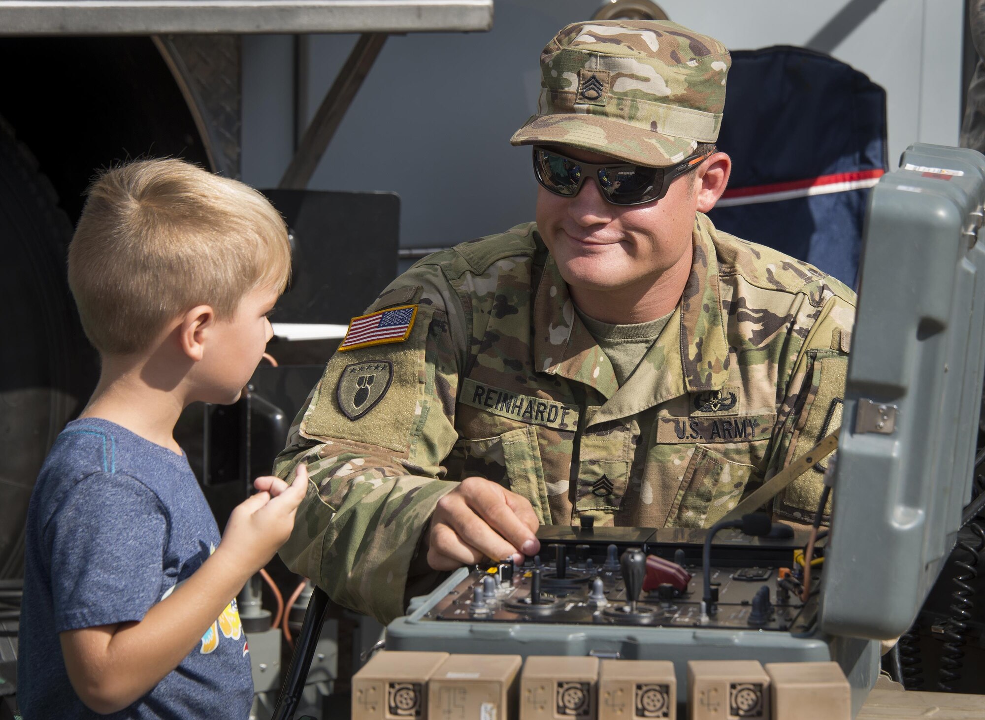 Staff Sgt. Michael Reinhardt, Army Explosive Ordnance Disposal Training Detachment, teaches a child how to control an EOD robot during a demonstration Nov. 5 at Eglin Air Force Base, Fla. The Air Force Armament Museum hosted the Northwest Florida 50th Vietnam War Commemoration Celebration event to honor veterans’ service and sacrifices.  Event activities included a military working dog demonstration, explosive ordnance removal robots, Army Ranger reptile display, a speaker’s panel and an AC-130 tour.   (U.S. Air Force photo/Kristin Stewart)