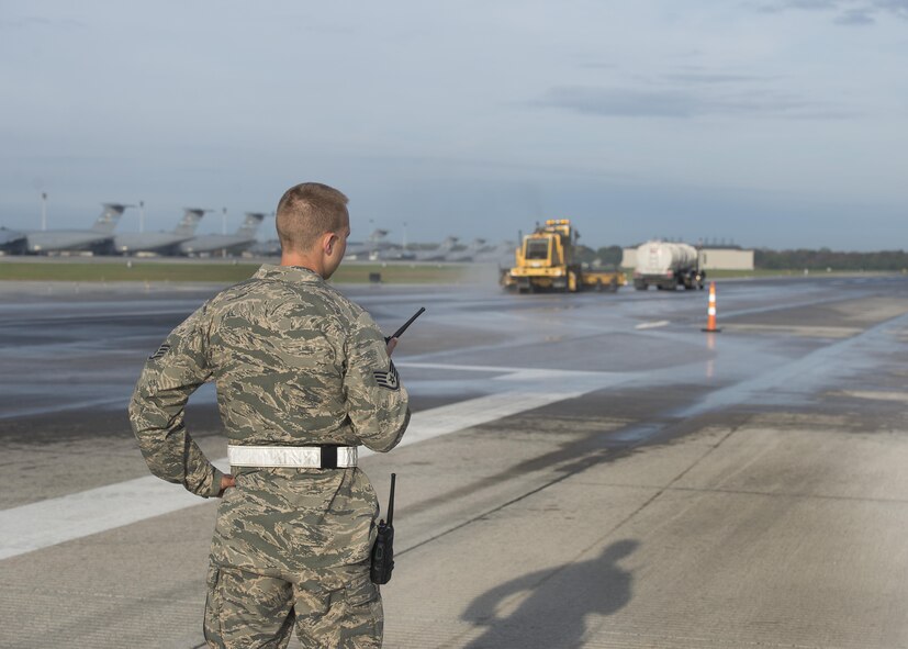 Staff Sgt. Patrick Murphy, 436th Civil Engineer Squadron Heavy Repairs Flight pavements and construction equipment operator, oversees rubber removal operations on Runway 14-32 Nov. 1, 2016, at Dover Air Force Base, Del. Murphy and seven other ‘Dirt Boys’ were out on the runway from 6 a.m. until the early evening completing the appropriate tasks necessary to safely and effectivity remove the built up rubber residue. (U.S. Air Force photo by Senior Airman Zachary Cacicia)