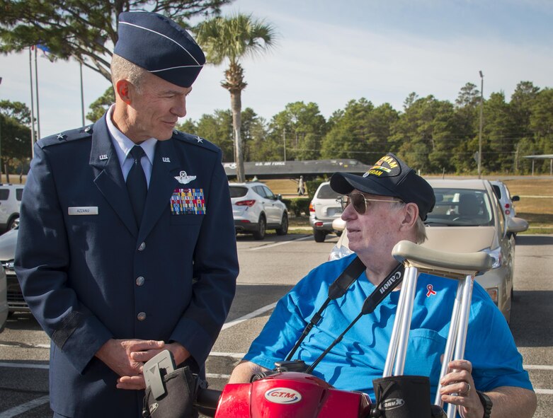 Brig. Gen. Christopher Azzano, the 96th Test Wing commander, thanks a Vietnam veteran for his service Nov. 5 at Eglin Air Force Base, Fla. The Air Force Armament Museum hosted the Northwest Florida 50th Vietnam War Commemoration Celebration event to honor veterans’ service and sacrifices.  Event activities included a MWD demonstration, explosive ordnance removal robots, Army Ranger reptile display, a speaker’s panel and an AC-130 tour. (U.S. Air Force photo/Kristin Stewart)